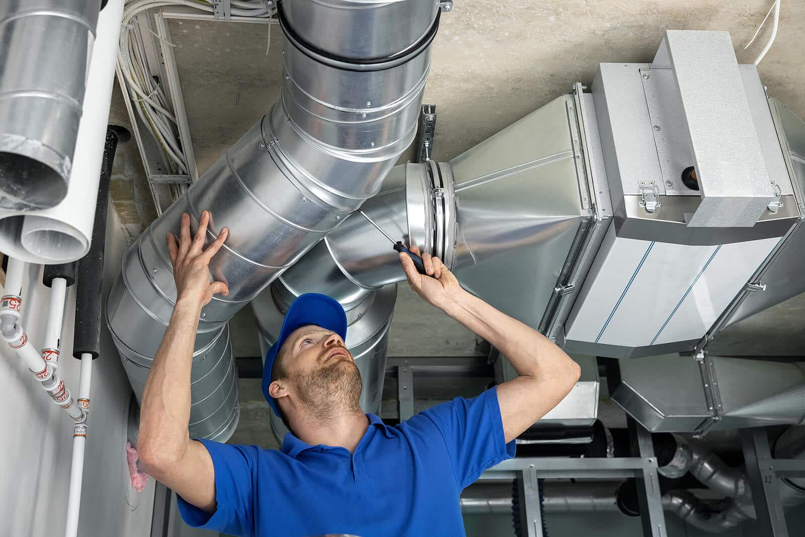 HVAC technician inspecting and repairing air ducts in Dublin