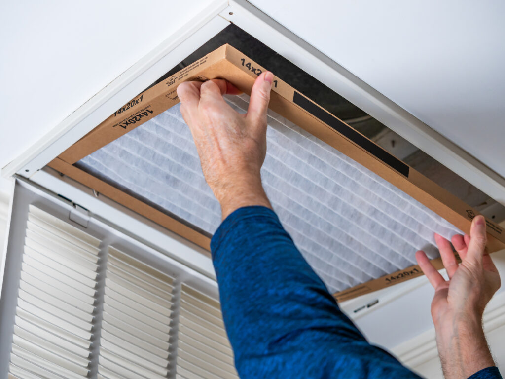 HVAC technician replacing a home air filter in Dublin