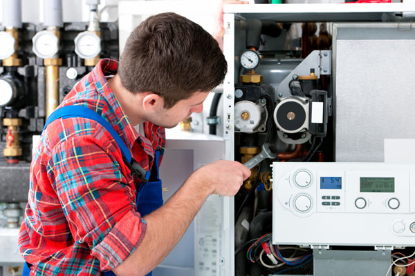 Heating technician repairing boiler controls in Dublin