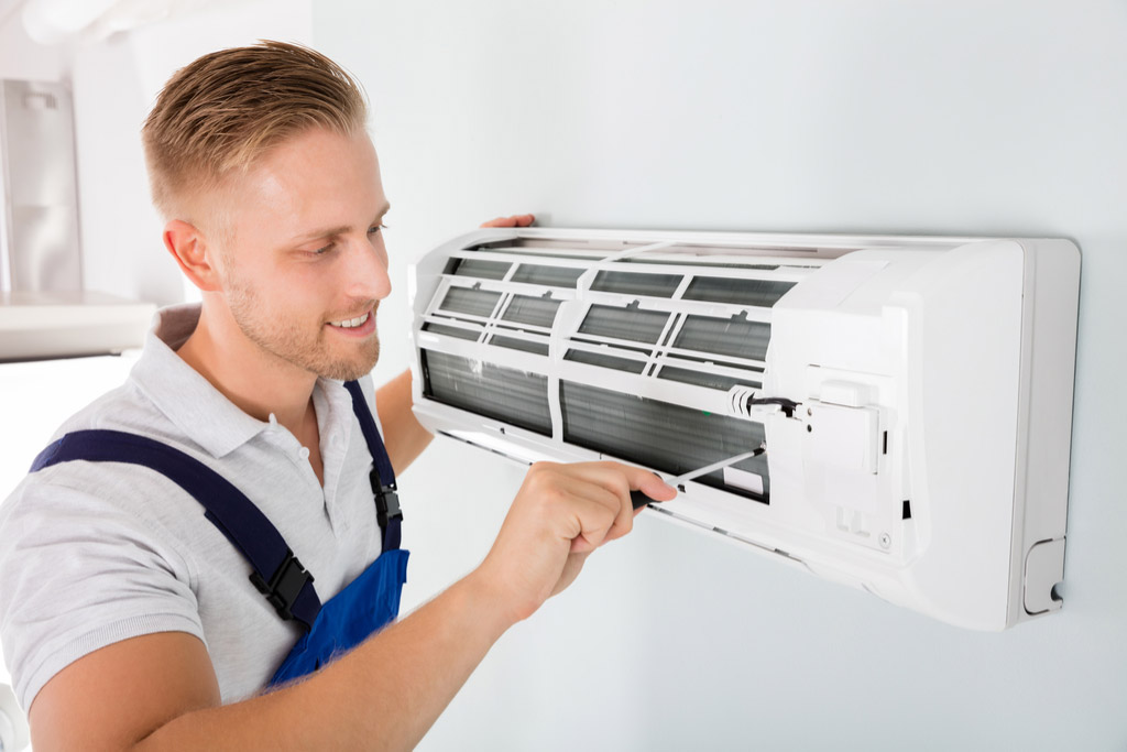 HVAC technician maintaining a ductless air conditioner in Dublin