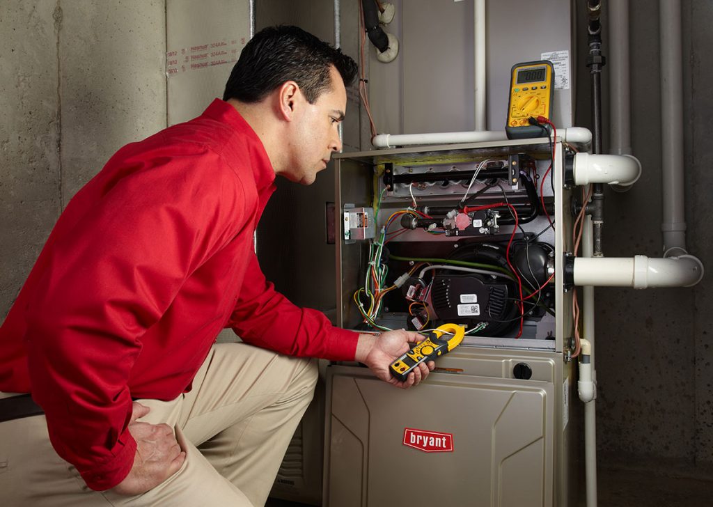 Heating technician diagnosing a furnace repair in Dublin
