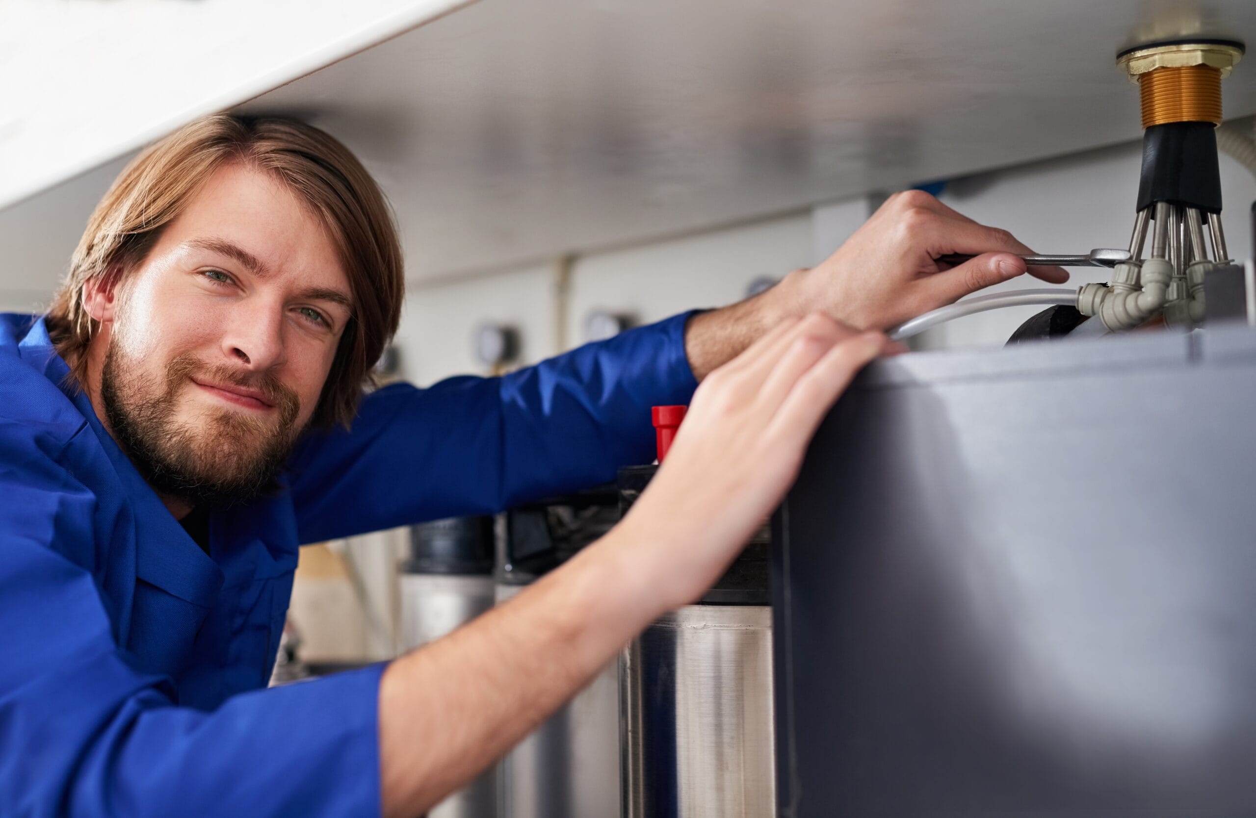 Technician servicing a residential water heater tank in Dublin